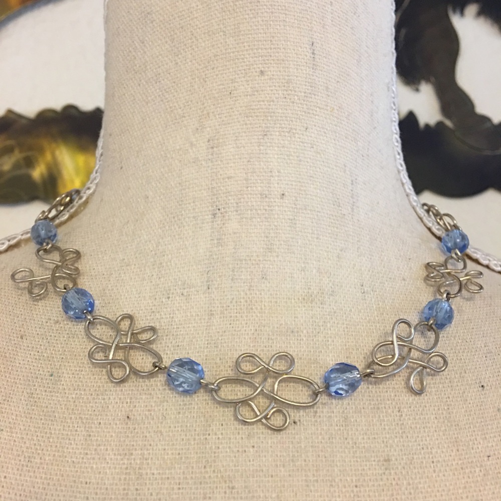 Silver scroll design blue faceted bead necklace